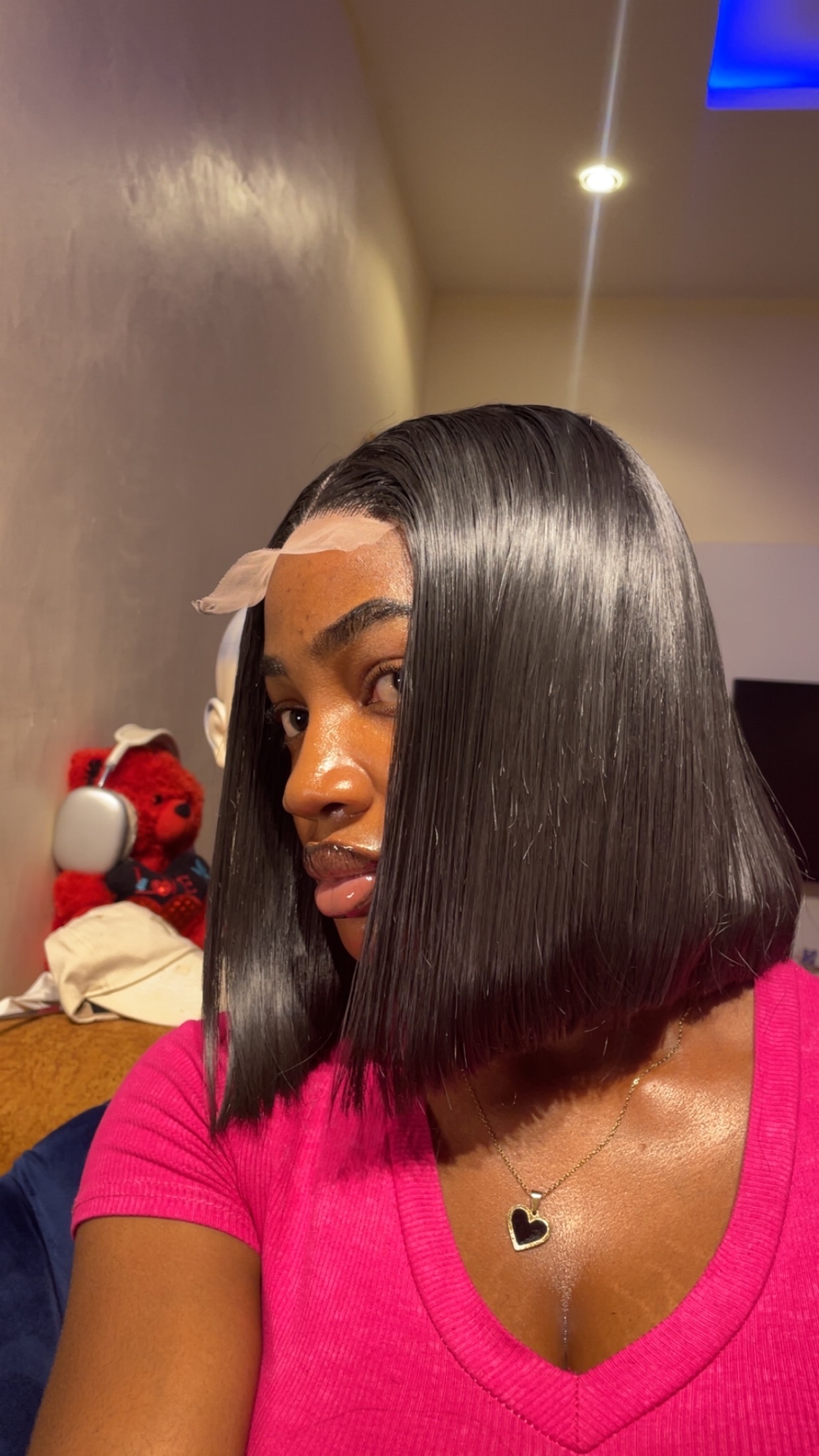 Side view of a sleek bone straight bob wig installation by DeLuxury Wigs
